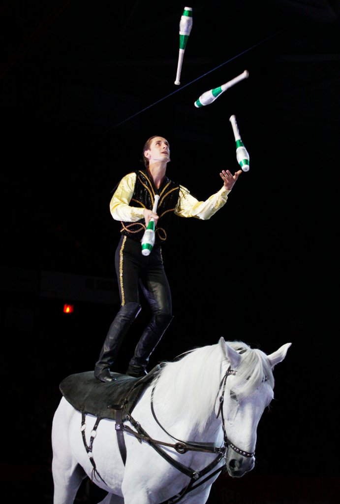 A performer juggles while perched atop a horse during a circus performance at the Cumberland County Civic Center on Thursday.