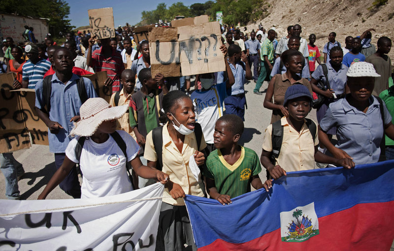 Protesters who blame U.N. peacekeepers from Nepal for Haiti’s widening cholera epidemic march on a rural military base in Mirebalais, Haiti, on Friday to demand the soldiers leave the country. More than 4,700 people have been hospitalized and at least 330 have died.