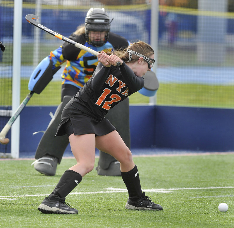 Megan Fortier of North Yarmouth Academy lines up a shot Saturday against Foxcroft Academy goalie Cassie Curtis. NYA won the Class C field hockey title on penalty corners.