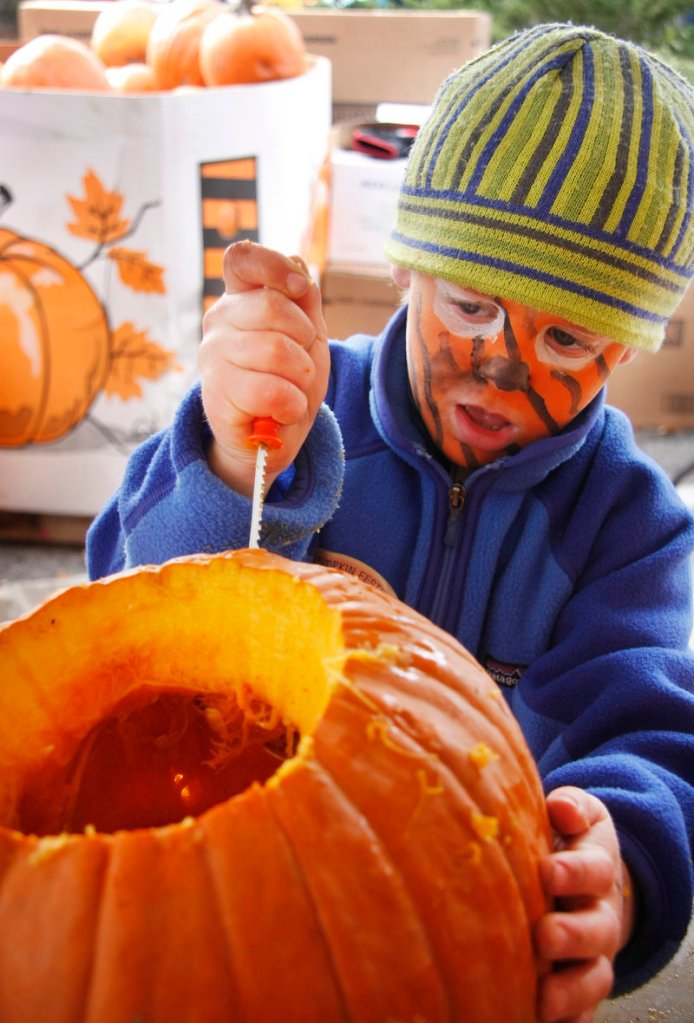 Peter Towne, 5, of Freeport tries his hand at carving.