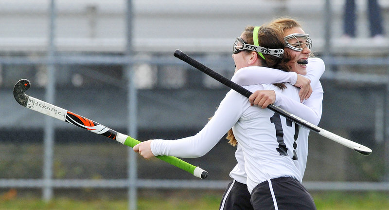 Jessica Skillings, front, gets a congratulatory hug after scoring one of her two goals Saturday for Skowhegan in a 3-0 victory over Cheverus in the Class A state field hockey final at Orono. Skowhegan finished 18-0 with just two seniors on the team.