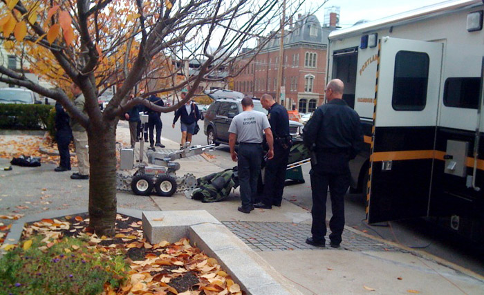 Police bomb specialists pack up their equipment after the bomb scare at the federal courthouse today.