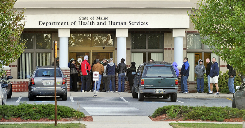 People line up outside the Maine Department of Health and Human Services office on Marginal Way in Portland before it opens at 8 a.m. Maine's gubernatorial candidates have widely differing views about welfare.