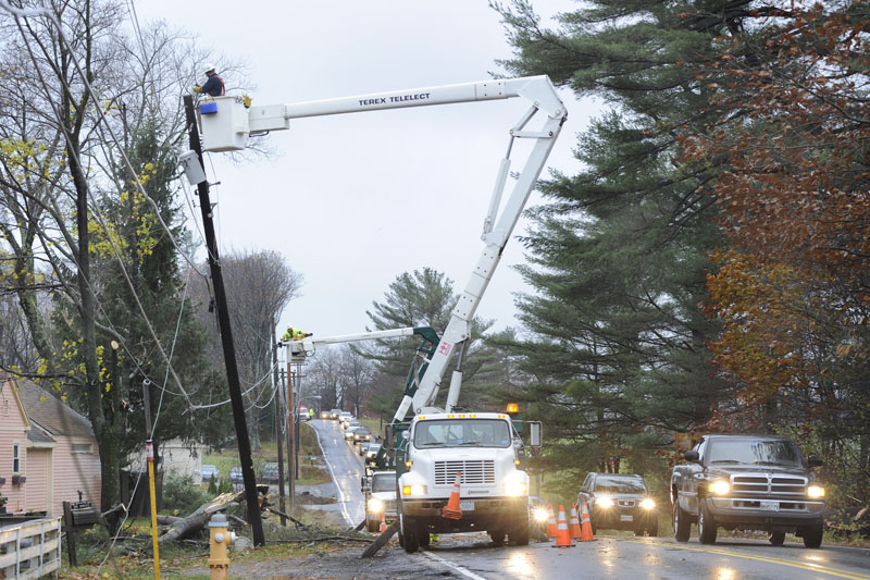 Route 22 on the Scarborough/Westbrook line has re-opened to one lane after trees knocked down power lines. Utility crews like this one are busy all over Maine restoring power for up to 50,000 residents.