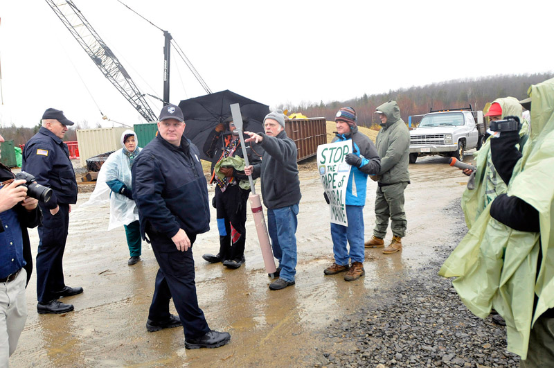 Staff Photo by Shawn Patrick Ouellette: Protesters gathered at the Rollins wind energy project in Lincoln listen to the police as they ask them to move of Rollin's property Monday, Nov. 8, 2010.