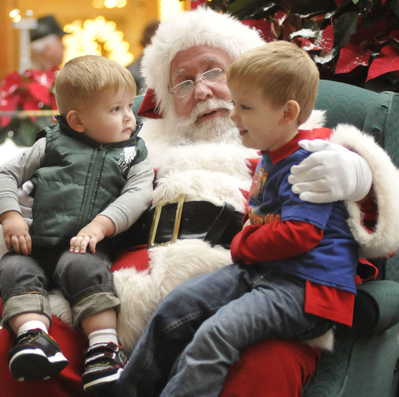 Staff Photo by Shawn Patrick Ouellette: Daniel Barry , 23 months and Patrick Barry 4, of Sidney, talk with Santa during a trip to the Maine Mall Monday, Nov. 15, 2010.