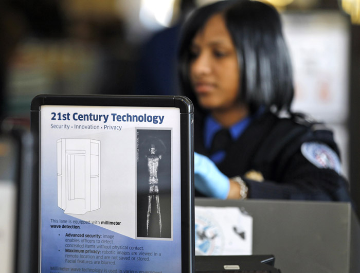 A sign helps explain the new technology to travelers at a TSA security checkpoint at Washington's Ronald Reagan National Airport today.