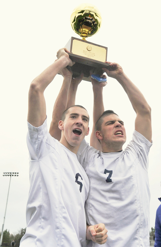 Yarmouth team captains Kyle Groves, left, and Campbell Belisle-Haley celebrate their team's Class B state championship win over Ellsworth today.