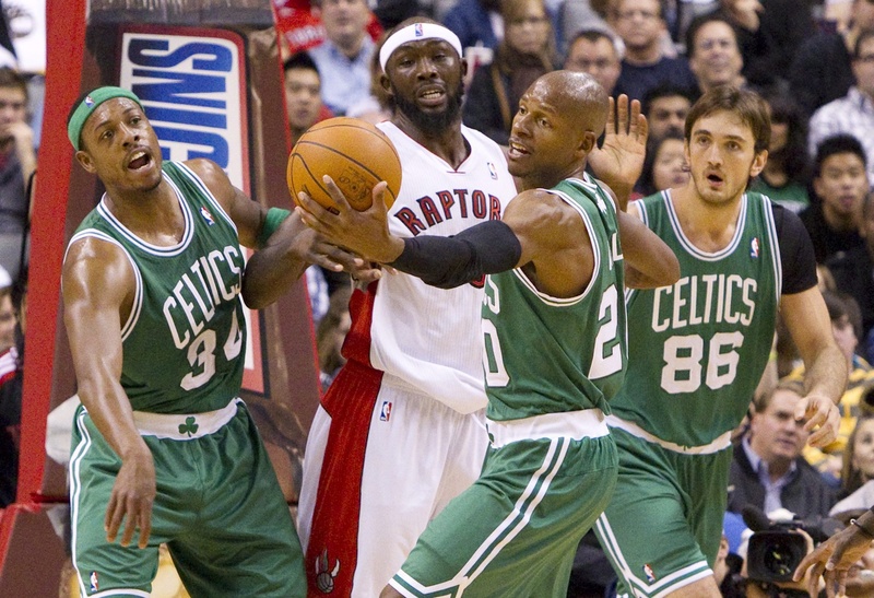 Toronto Raptors' Reggie Evans fights for a loose ball with Paul Pierce, left, Ray Allen, and Semih Erden of the Celtics in today's game at Toronto. The Raptors won, 102-101.