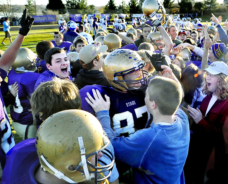 Fans and other team members swamp Christian Deschenes of Cheverus after the Stags beat Deering by one point in the Western Maine Class A football championship at Cheverus today. Cheverus will play Bangor for the state title next Saturday at Fitzpatrick Stadium