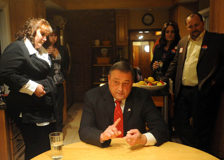 Paul LePage answers questions from Morning Sentinel reporter Amy Calder in his kitchen at his Waterville residence surrounded by family as poll numbers roll in late Tuesday night.