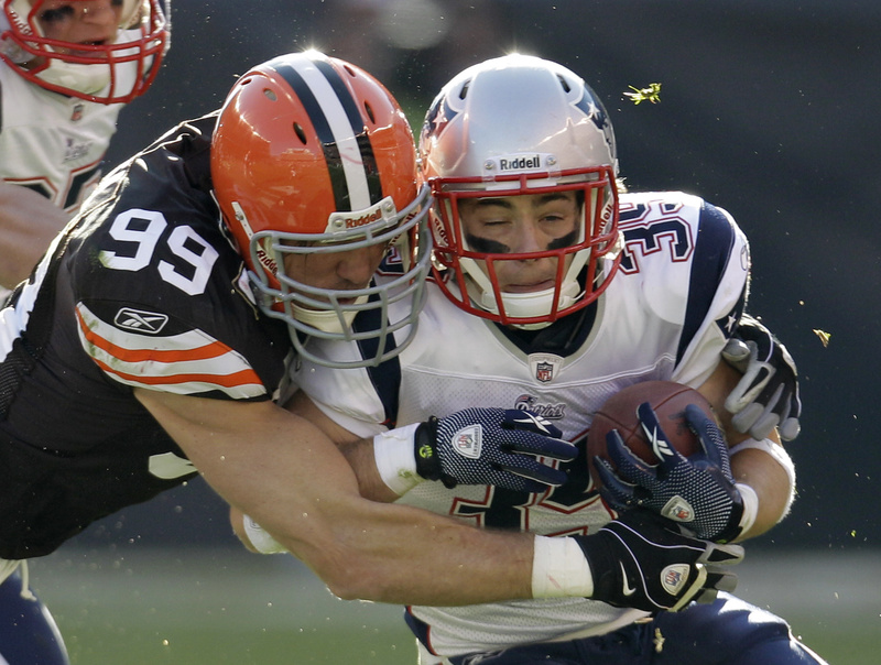 Linebacker Scott Fujita stops running back Danny Woodhead of the Patriots after a 6-yard run in the second quarter Sunday in Cleveland. The Browns surprised the Pats with a 34-14 win.