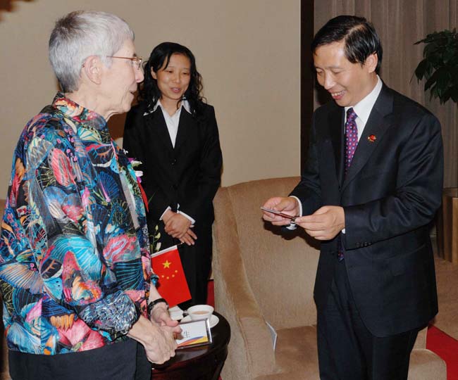 From left: Theodora Kalikow, president of the University of Maine at Farmington, is assisted by a translator as she is welcomed to China by Guo Guangsheng, president of Beijing University of Technology.