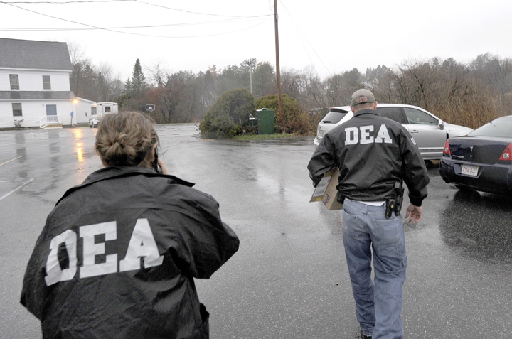 DEA agents leave the offices of Dr. John Perry at Atlantic Foot & Ankle Center at 1711 Congress St. in Portland this morning after seizing boxes of medical records.