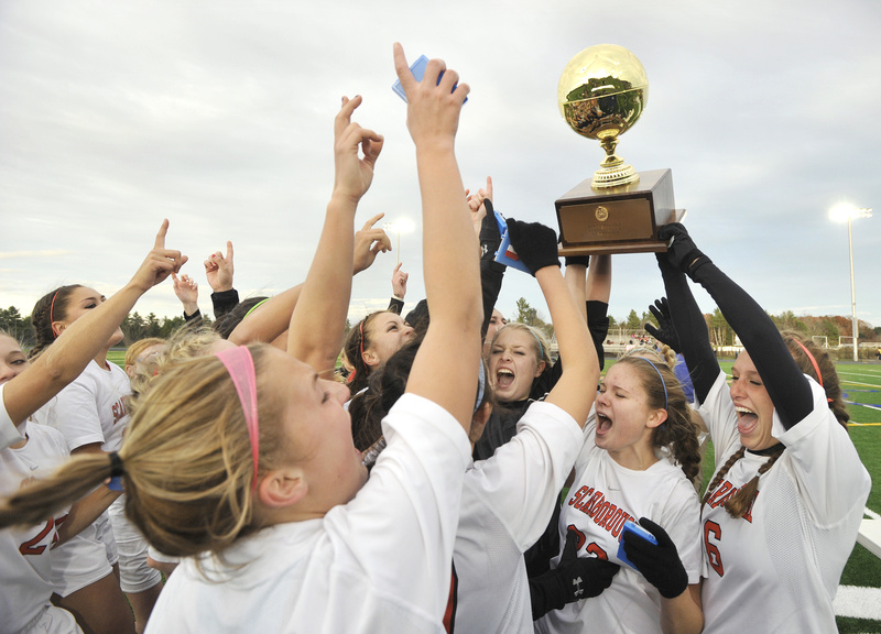 The Scarborough girls lift their Class A championship trophy today after beating Bangor 3-0 at Falmouth Stadium. Scarborough allowed only one goal all season.