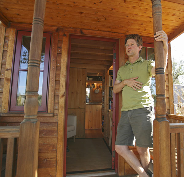 Jay Schafer, owner of Tumbleweed Tiny Houses, stands on the front porch of a tiny house he built for himself in Graton, Calif. Schaefer, who lived in a 89-square foot house with his wife before his son was born last year, builds houses that are smaller than most people's living rooms.