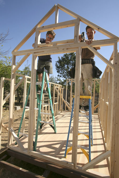 Jay Schafer, owner of Tumbleweed Tiny Houses, left, works on construction of a frame with worker Zeke Gifford in Graton, Calif.