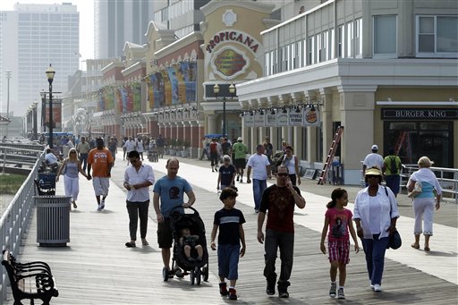 People stroll on the boardwalk in Atlantic City, N.J., in this Sept. 2 photo. Though the city is seeing fewer visitors, those that come are spending more on nongambling activities.