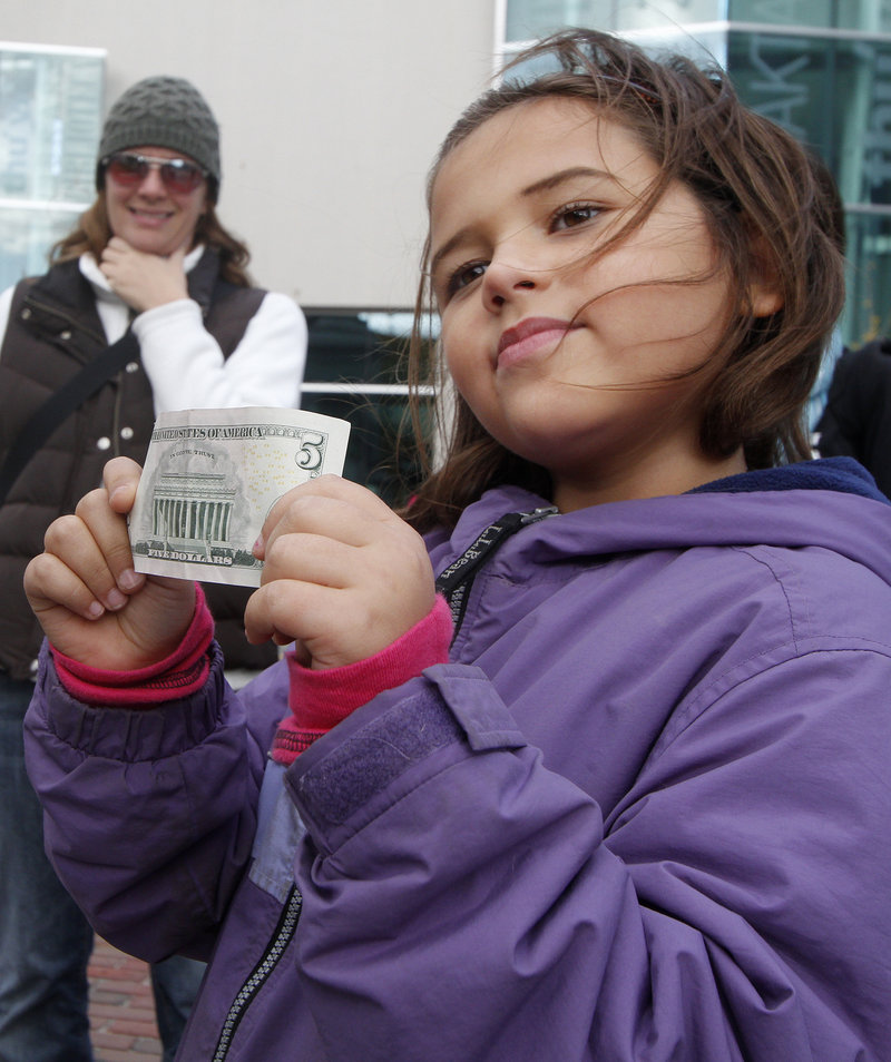 Sia Hyson, 7, of Gorham tries to decide what to buy to brighten other people's lives with the $5 her mom gave her.