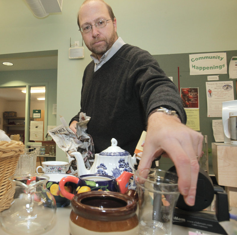 Reporter Ray Routhier unpacks and sorts items at the Freeport Community Center Thrift Shop.