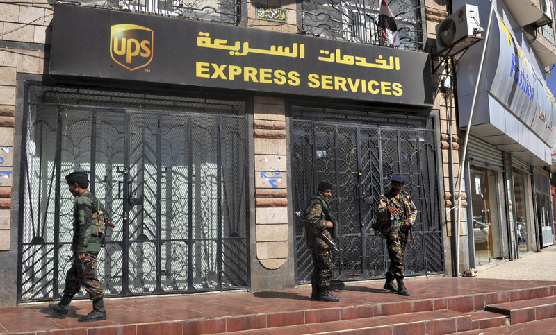 Yemeni security forces stand outside the UPS office in the capital San’a on Sunday. U.S. and Yemeni officials met Sunday to plan a response to the discovery of two bombs mailed on planes bound for the U.S. The Yemen-based militant faction Al-Qaida in the Arabian Peninsula is believed to be behind the plot.