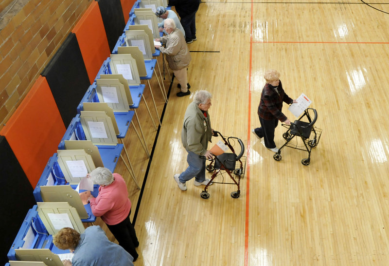 A pair of voters in Biddeford walk away from voting booths at the J. Richard Martin Community Center in Biddeford on Tuesday, Despite its being an off-year election, many areas reported a heavy turnout of voters.