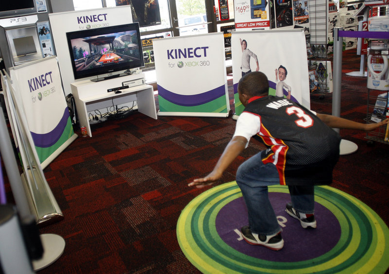 Michael McKoy, 11, checks out the Kinect sensor system on an XBOX 360 at a Charlotte, N.C. Gamestop. Microsoft’s new sensor lets users control games through body motions, similar to Nintendo’s Wii system.