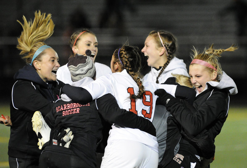 Jessica Broadhurst, 19, of Scarborough celebrates with her teammates Wednesday night after the Red Storm won the Western Class A title with a 1-0 victory against Thornton Academy.