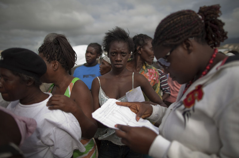 Women wait in line to be evacuated from the Corail-Cesselesse tent refugee camp in Port-au-Prince, Haiti, before the arrival of Tropical Storm Tomas on Thursday.