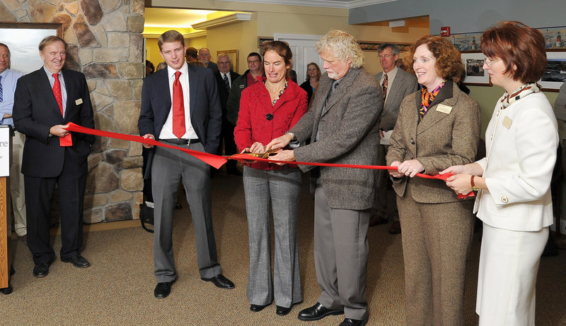 Sara Lennon, third from left, chairman of the finance committee of the Cape Elizabeth Town Council, gets help from Lon Walters, CEO of Woodlands Assisted Living, as they cut the ribbon at Thursday’s grand opening of Cape Memory Care. Others from left are: David Rogers, director of admissions and community relations; Matthew Walters, chief operating officer for Woodlands Assisted Living; Mary Smith, R.N., director of resident health care; and Olga Gross-Balzano, executive director of the new facilty.