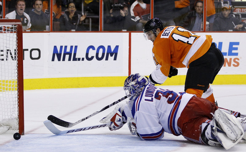 Blair Betts of the Flyers pushes the puck past Rangers goalie Henrik Lundqvist for one of Philadelphia’s three second-period goals Thursday night in a 4-1 victory.