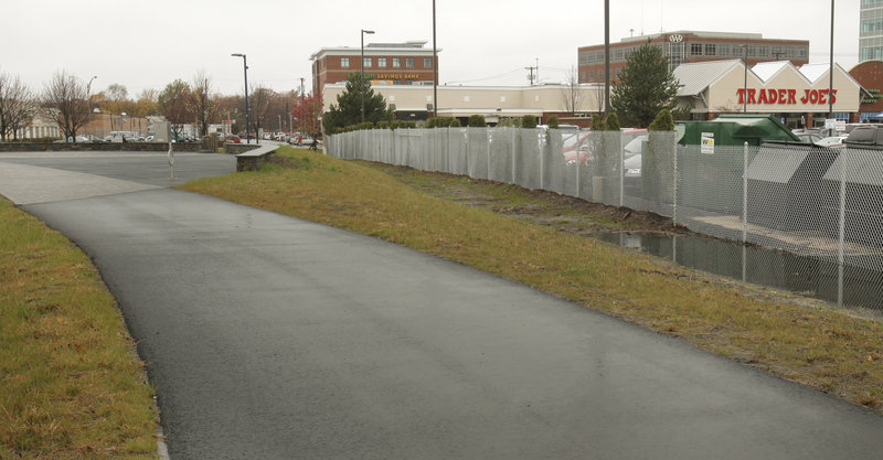 The fence separating the Trader Joe’s parking lot from the Bayside Trail has generated complaints from trail users who want pedestrian and bicycle access to the store.