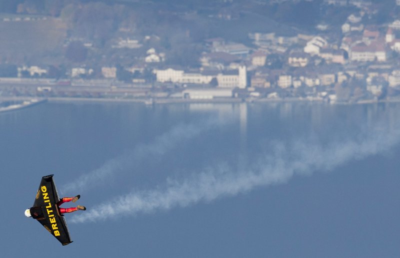 Swiss pilot Yves Rossy, the first man in the world to fly under a jet-fitted wing, speeds through the air to perform a loop in Bercher, western Switzerland, on Friday.