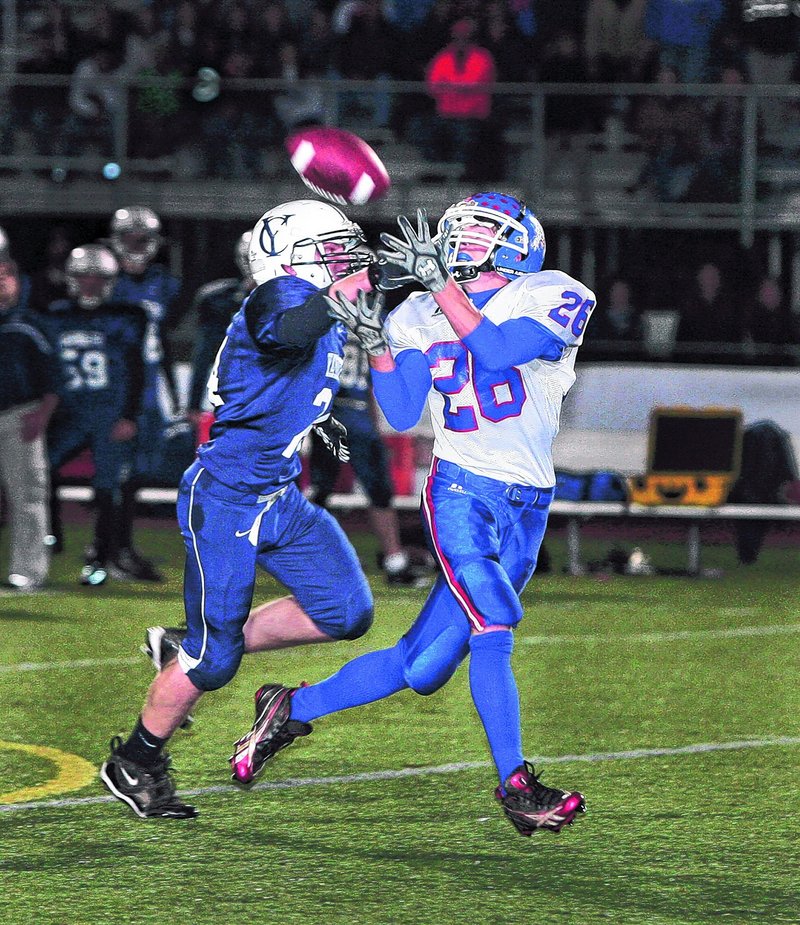 Craig Morrill of Oak Hill gets a step on Anders Overhaug of Yarmouth to haul in a first-quarter pass Friday night. Morrill also caught a 73-yard pass in the third quarter his team s only score as Yarmouth came away with a 28-7 victory at home.