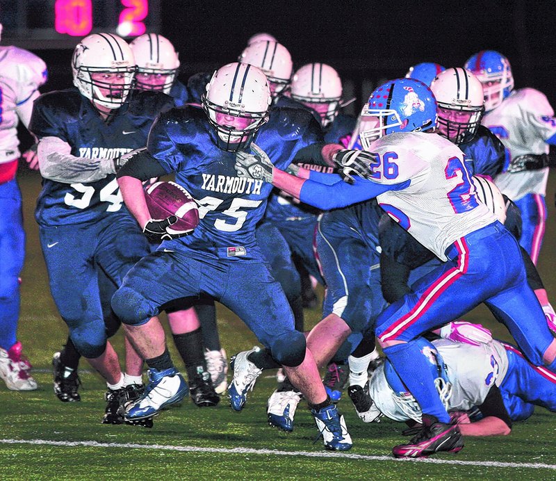 Billy Clabby of Yarmouth breaks away from Craig Morrill of Oak Hill on a second-quarter run Friday night. It set up the Clippers second touchdown in what became a 28-7 victory in a Western Class C semifinal. Yarmouth will meet Winthrop or Lisbon, who play today.