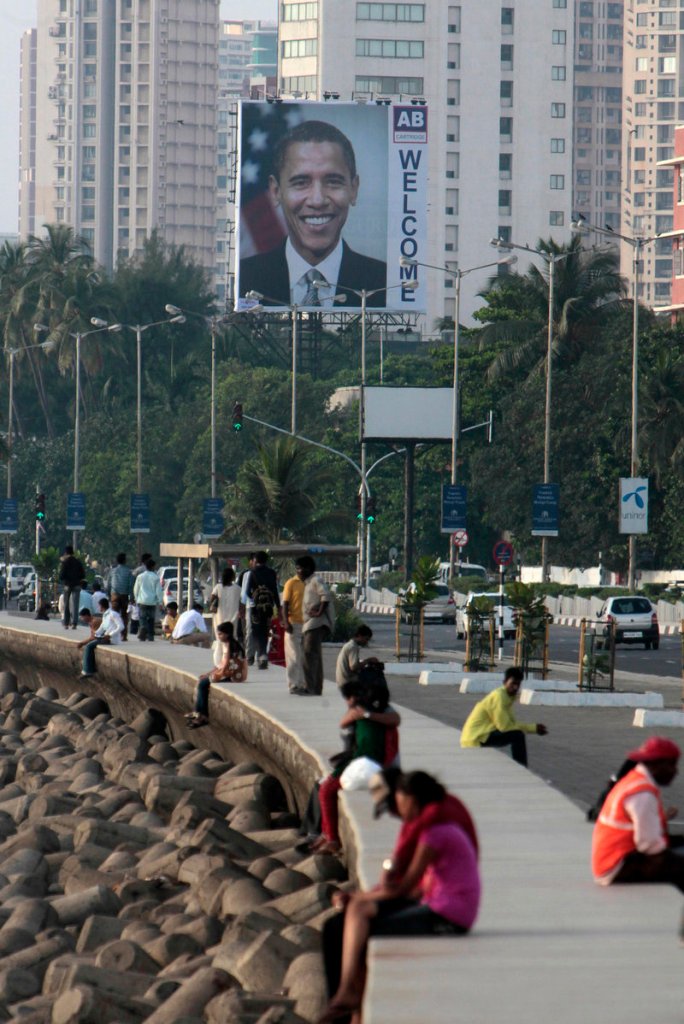 A billboard of President Obama rises above traffic Friday on Marine Drive in Mumbai, India. Obama is scheduled to spend about a day and a half in the city before heading to the capital of New Delhi for meetings with government leaders including the prime minister.