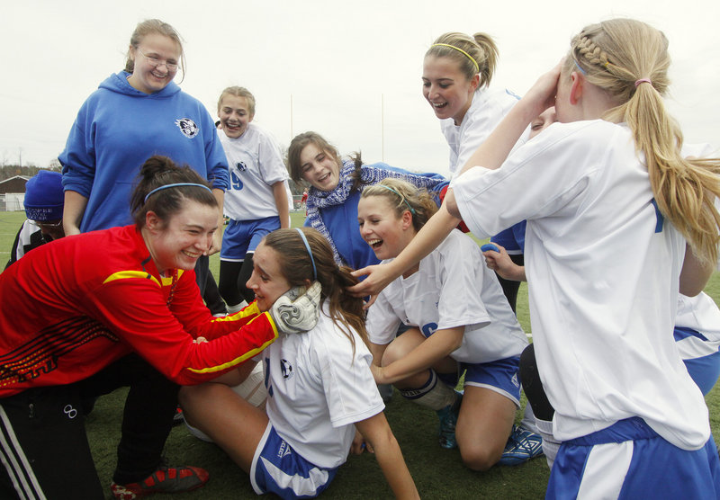 Emily Lane was on the ground and taking congratulations from teammates Saturday after scoring the overtime goal that gave Sacopee Valley its first girls soccer state title