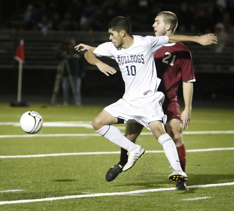 Fazal Nabi of Portland looks to get to the ball ahead of Adam King of Bangor during Bangor’s 3-2 victory Saturday in the Class A boys’ soccer state final at Falmouth.