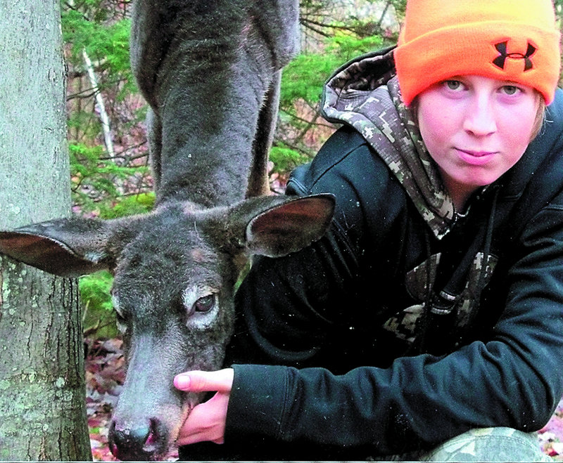 Levi Murray, 14, of Anson poses with the black deer he shot while hunting Nov. 2. Sightings of black deer are extremely rare in Maine, according to deer biologists.