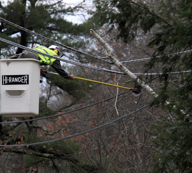 Scott Lovering of Readfield cuts away limbs that fell on power lines Monday in Yarmouth.