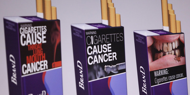 Illustrations of proposed warnings are shown on three sample cigarette packs. The more gruesome warnings could show emaciated cancer patients, diseased organs and corpses.