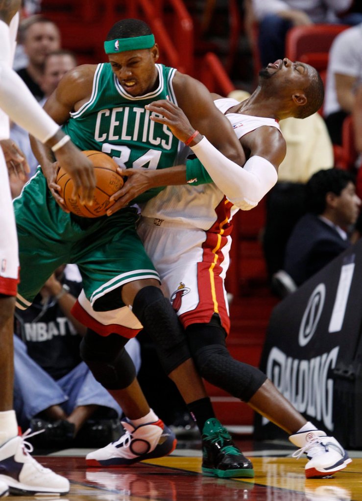 Paul Pierce of the Boston Celtics is called for an offensive foul as Dwyane Wade of the Miami Heat takes the charge in the first quarter of Boston’s 112-107 victory Thursday.