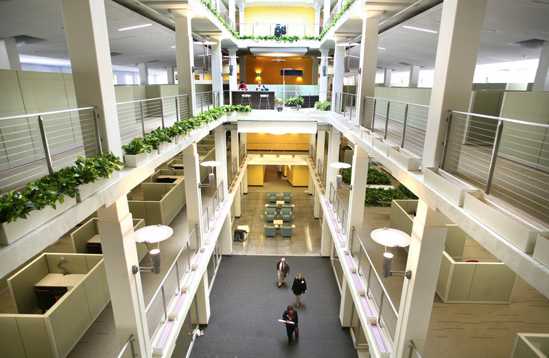 MaineHealth employees walk through the atrium during a tour of their new office space at 110 Free St. on Friday. The building formerly housed a Sears store and offices of Blue Cross and Blue Shield of Maine.