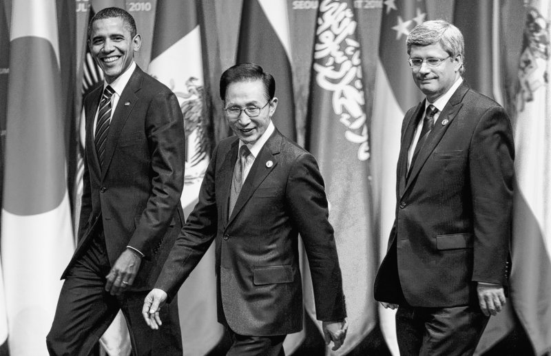 President Obama, left, and Canadian Prime Minister Stephen Harper flank South Korean President Lee Myung-bak as they walk onto the stage for an awards ceremony Friday at the G-20 summit in Seoul, South Korea.