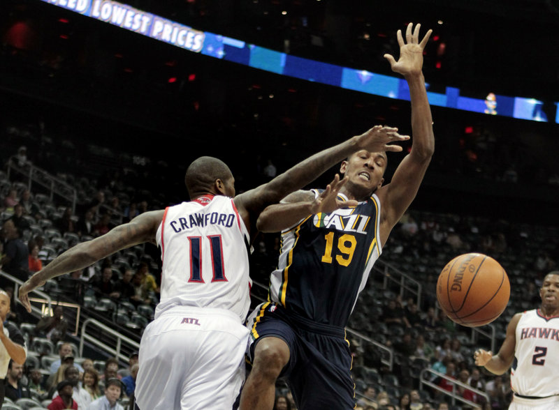 Utah Jazz guard Raja Bell is fouled by Atlanta Hawks guard Jamal Crawford during Friday night’s game in Atlanta. The Jazz came back to win from a double-digit, second-half deficit for the fourth straight game.
