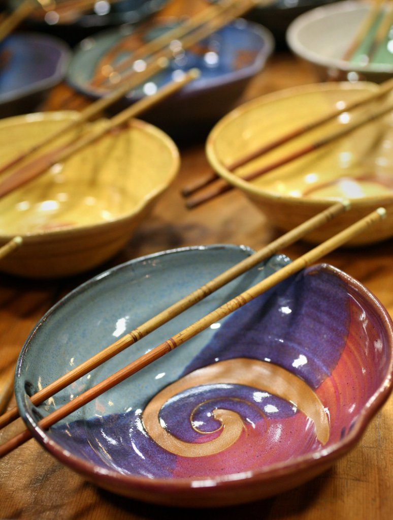 Stoneware clay rice bowls with chopsticks created by artist Keith Herklotz of Down to Earth Pottery in Blue Hill are part of the color of Saturday's show.
