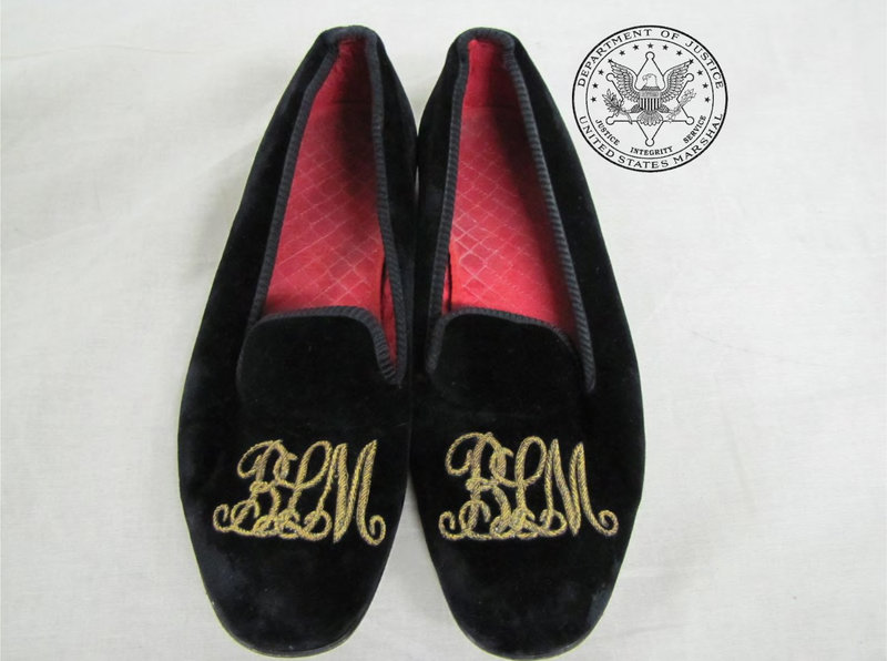 A pair of black velveteen slippers with “BLM” embroidered in gold thread were among thousands of belongings of Bernard Madoff on the auction block in New York on Saturday.