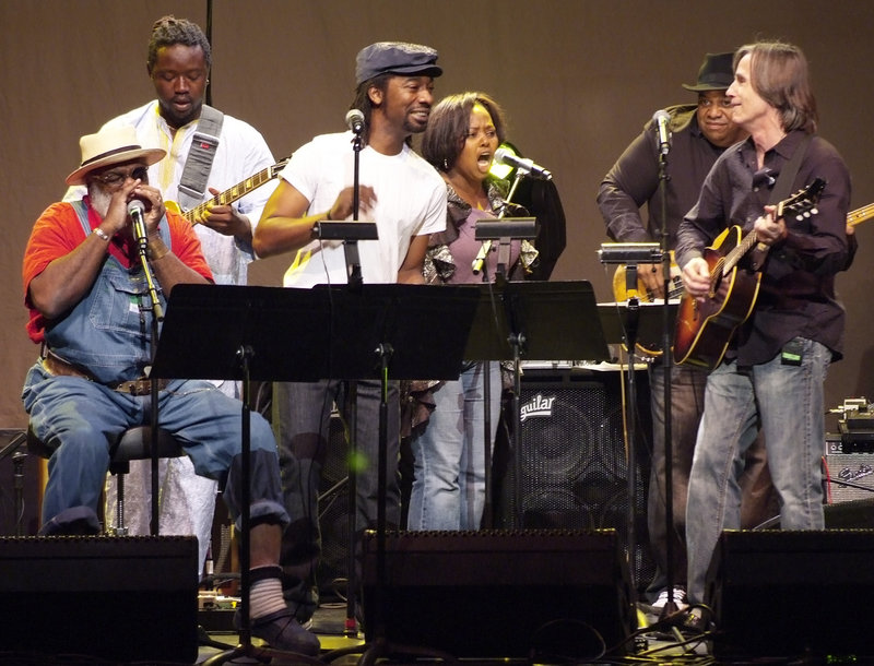 Musicians from Playing For Change and Jackson Browne, right, perform at the Theatre Within’s 30th annual John Lennon Tribute Concert at the Beacon Theatre in New York.