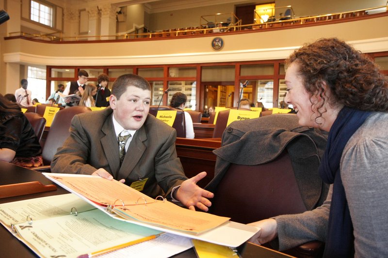 Winthrop High School sophomore Cameron Armstrong discusses a bill with Allyson Carmichael of Houlton High School in the State House chambers Saturday in Augusta. Armstrong was one of two Winthrop students taking part in this weekend’s Maine Youth in Government program.