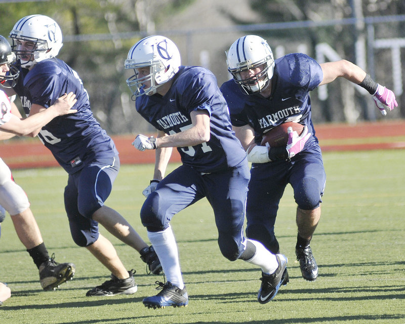 Nick Proscia, who gained 94 yards on 18 carries for Yarmouth, finds room while following his teammate, Asa Arden. The Clippers will take an 11-0 record into the state final.
